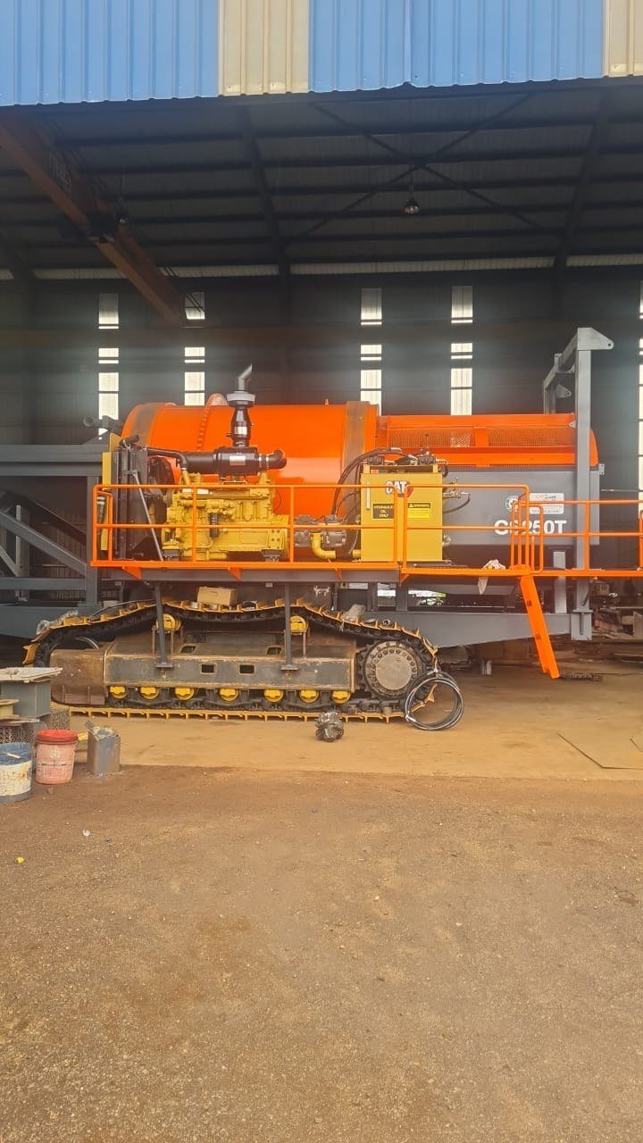 GS250T track-mounted gold trommel in the workshop, side profile showing crawler tracks and orange screen body
